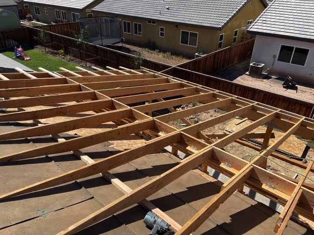 Patio cover roof joists framed over a backyard