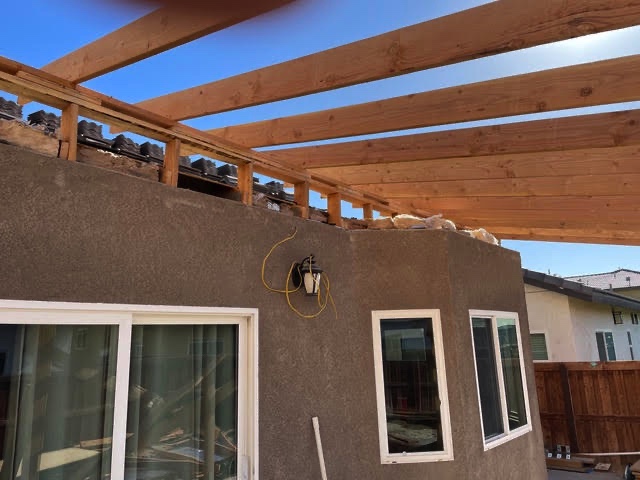 Solid patio cover beams tied into stucco wall